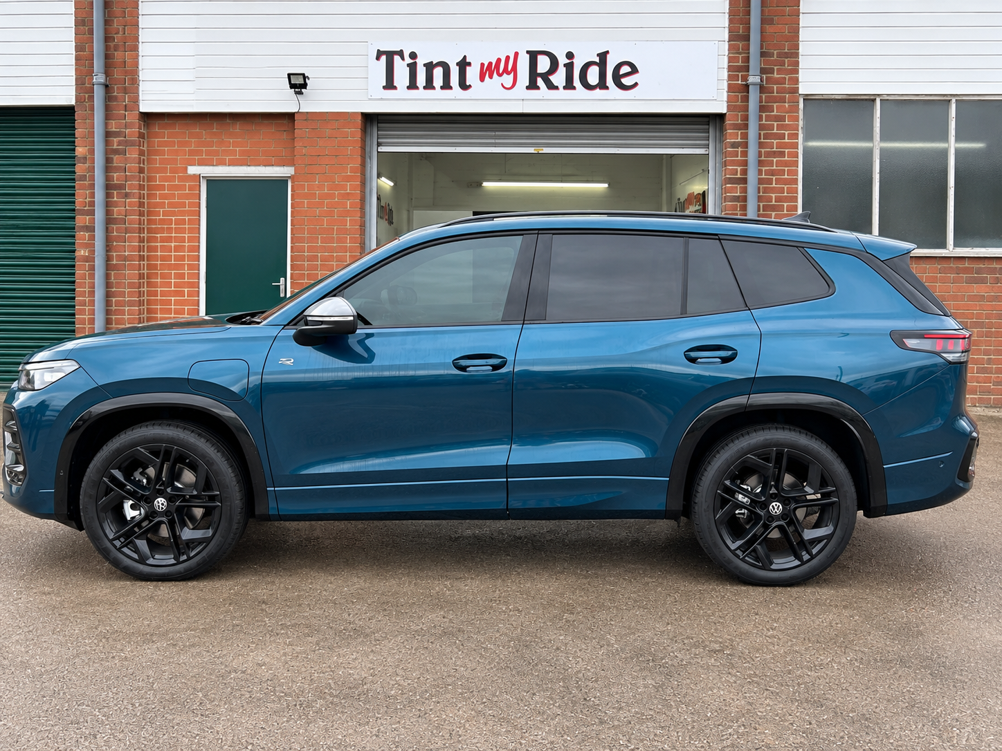 Teal SUV with rear privacy tint
