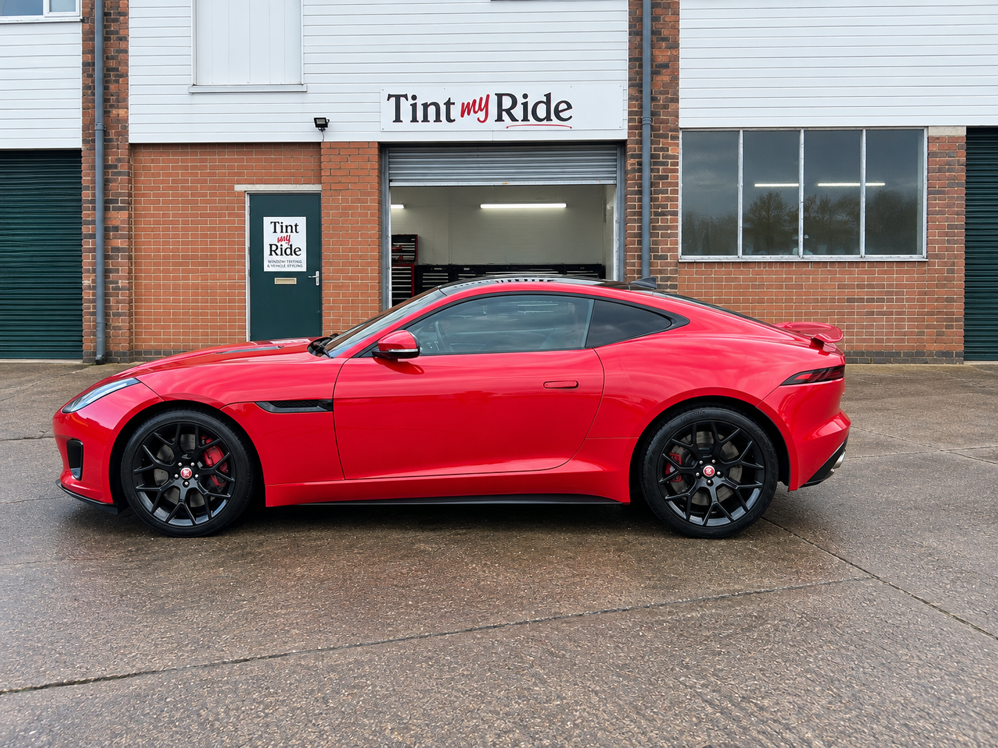 Red Ferrari coupe with tinted side glass