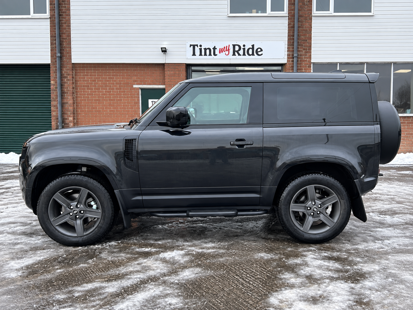 Grey Land Rover Defender with tinted glass