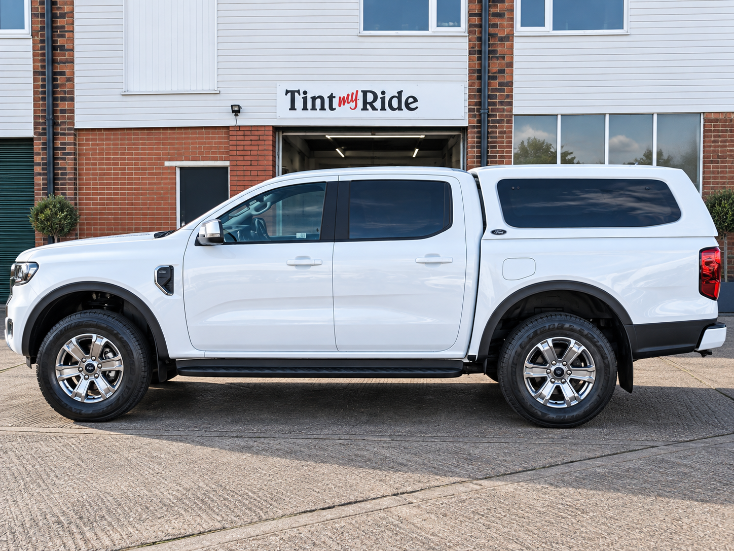 White pickup with tinted canopy glass
