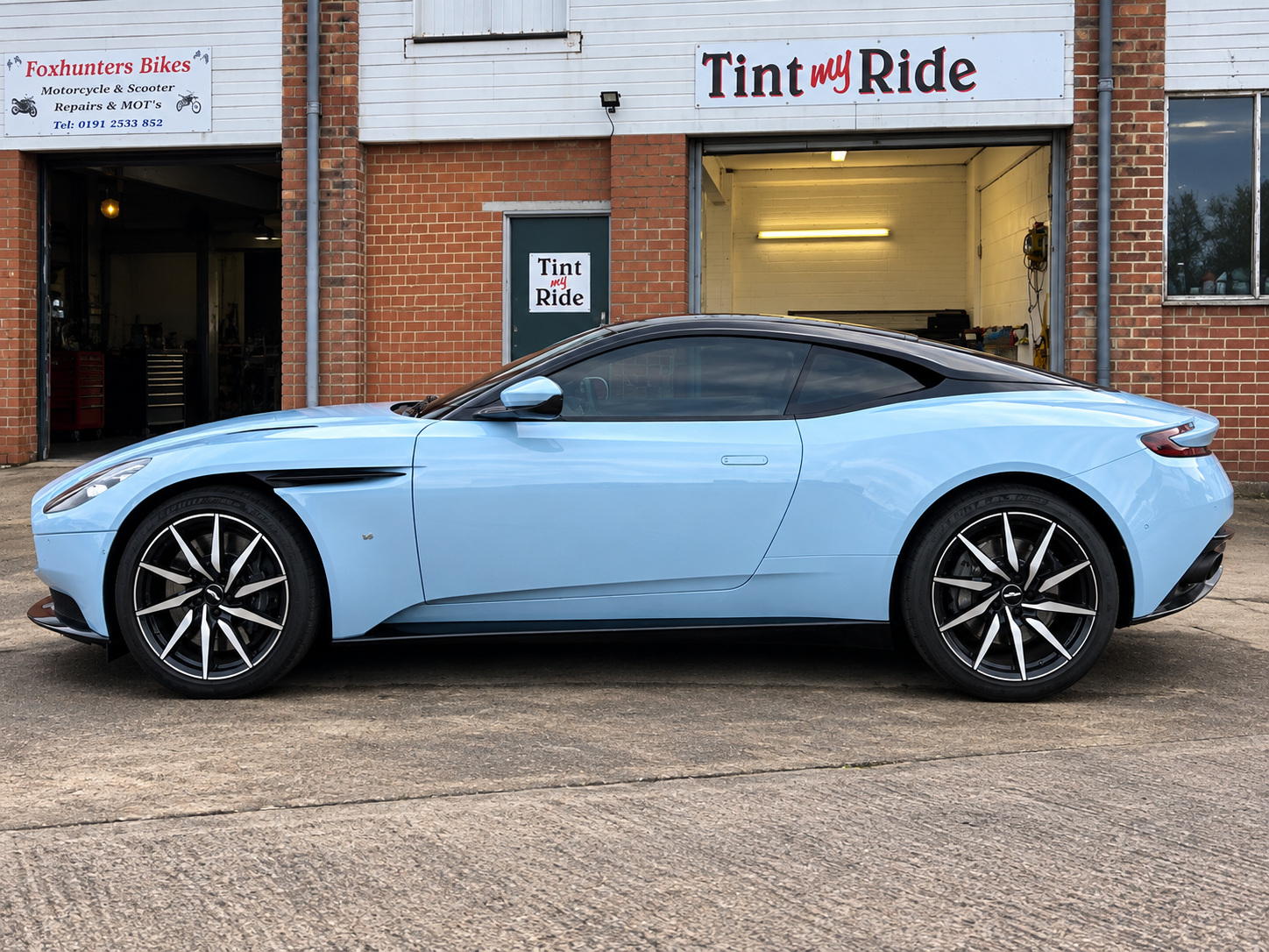 Blue Aston Martin outside Tint My Ride