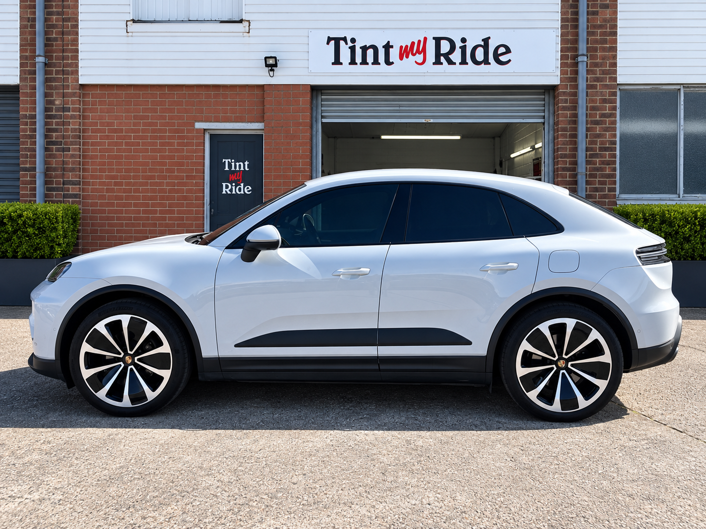 White Porsche Macan with dark rear tint