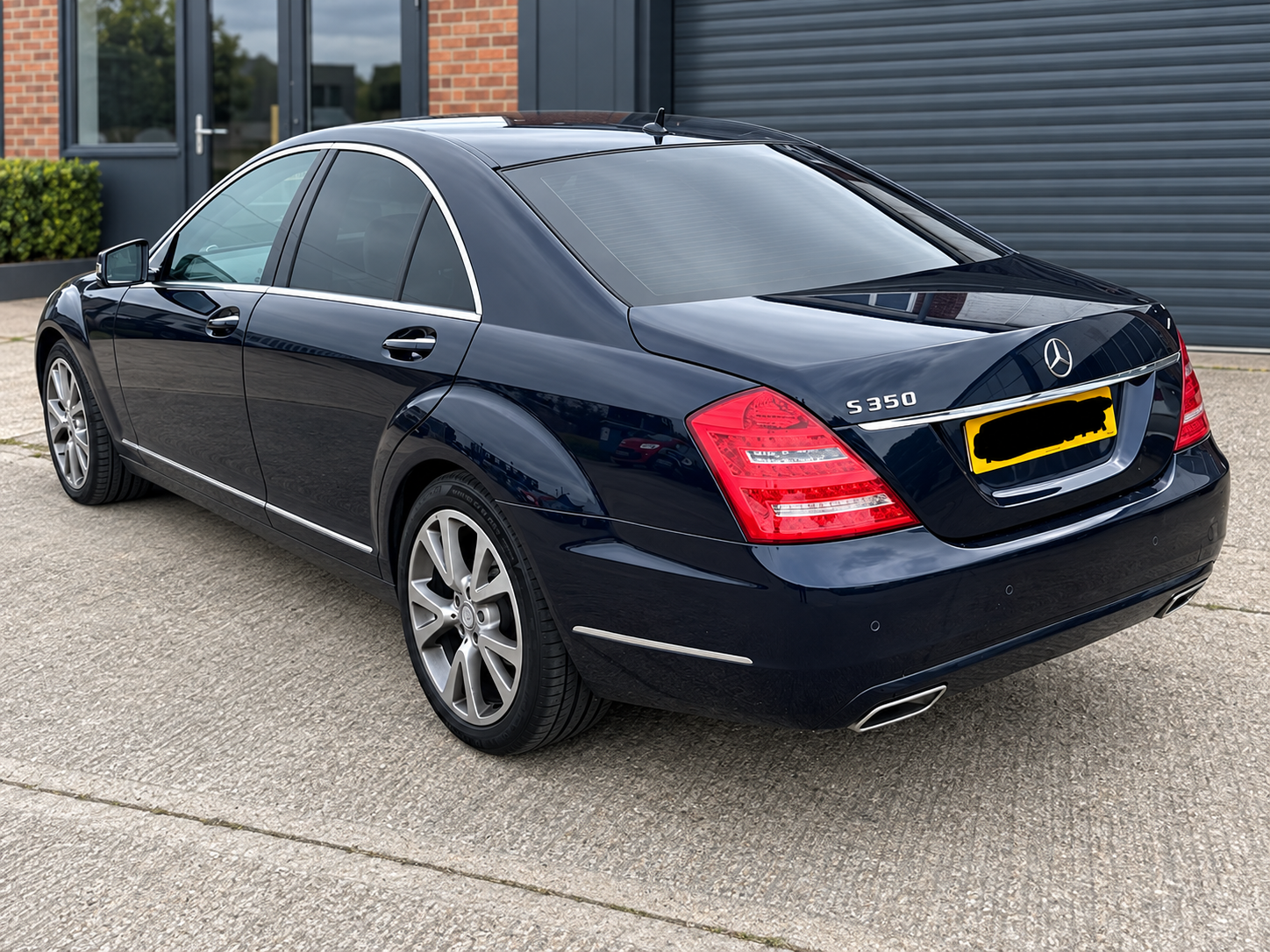 Blue Mercedes S-Class with tinted rear glass