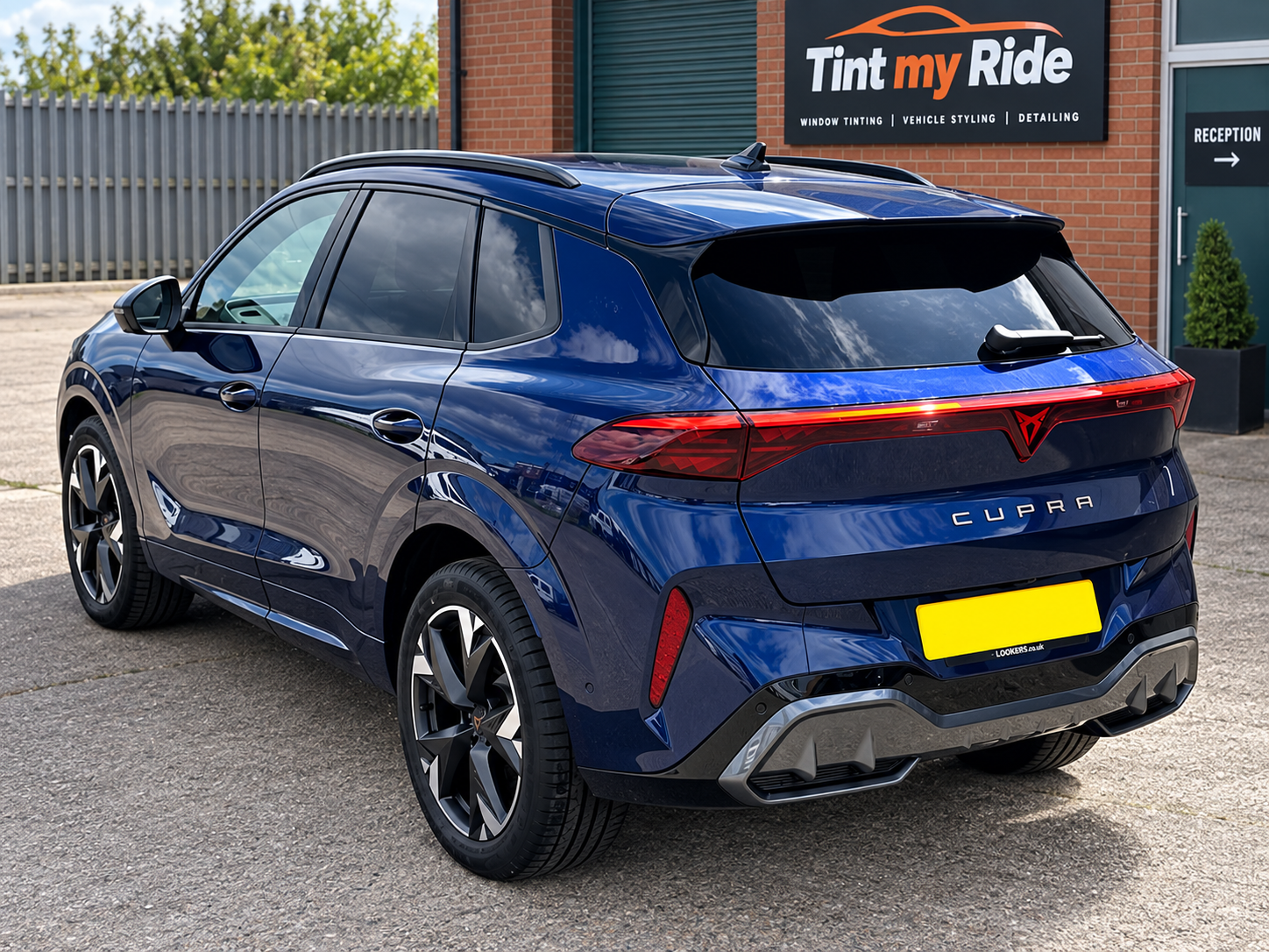 Blue Cupra SUV rear view with privacy tint