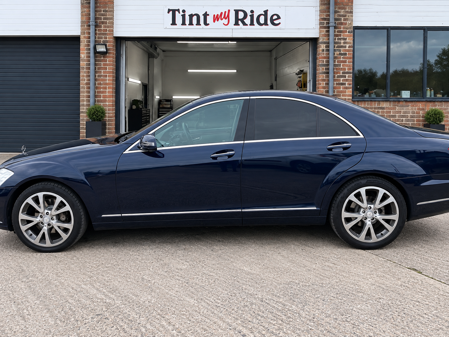 Blue Mercedes S-Class side profile with privacy tint